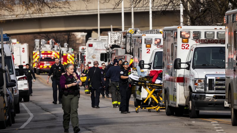 A person is taken away via ambulance after a Chicago Transit Authority train crashed into a...