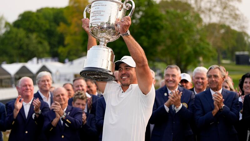 Brooks Koepka holds the Wanamaker trophy after winning the PGA Championship golf tournament at...