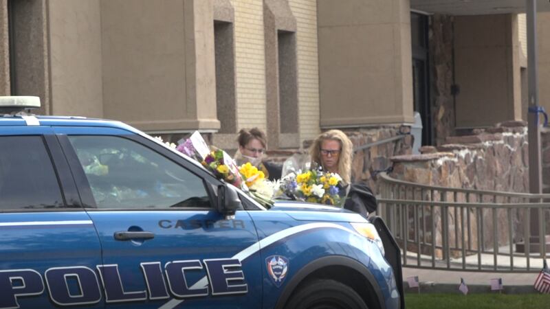 Casper residents place flowers on Officer Dundas' vehicle.